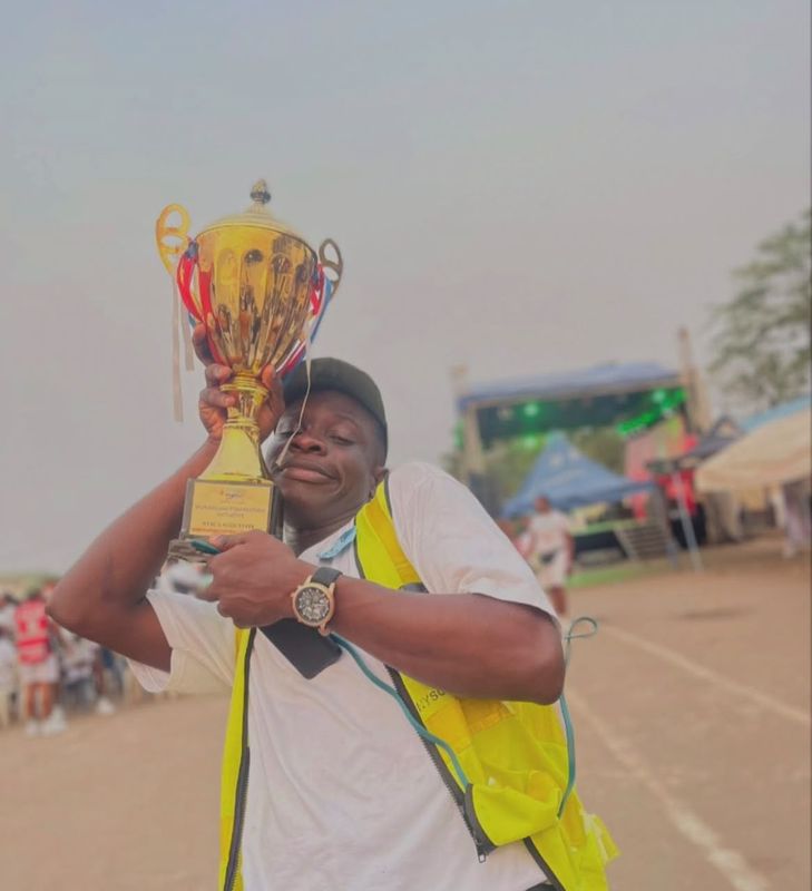 Joy lifting one of Platoon 4's trophies at the NYSC Lagos orientation camp